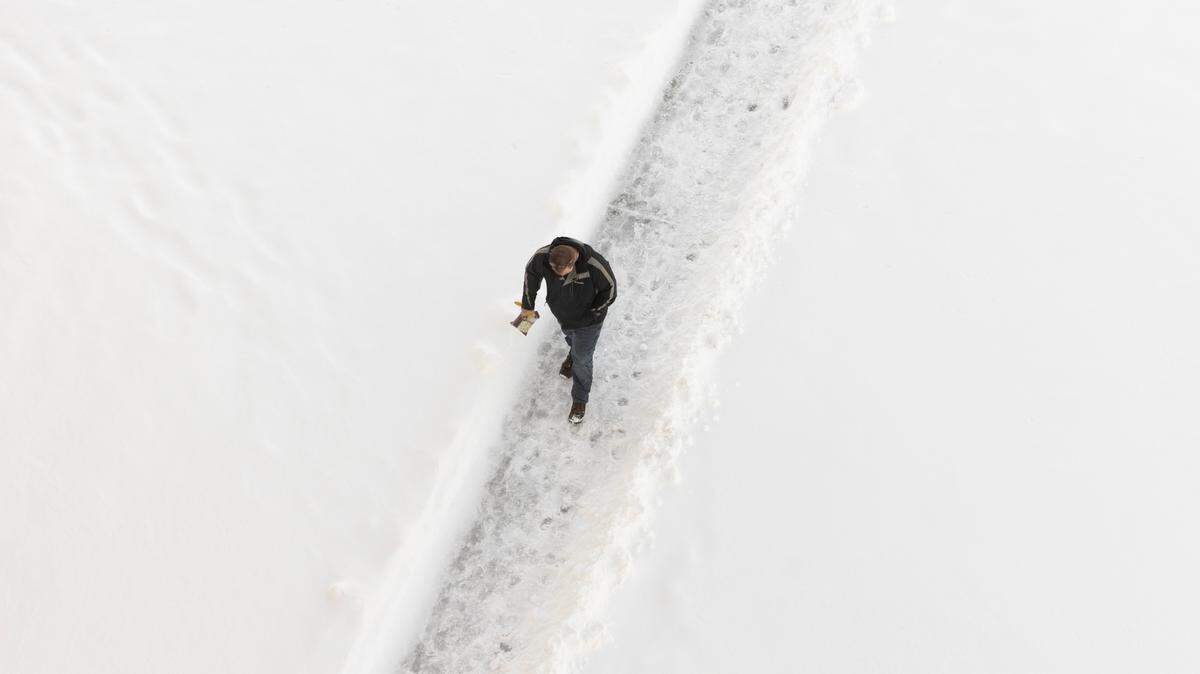 A pedestrian makes their way into the Epic Center a day after Wichita was blanketed with several inches of snow.