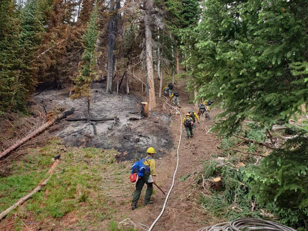 A Kansas crew works at the Muddy Slide Fire in Colorado earlier this month. The Muddy Slide Fire was caused by a lightning strike on June 15, and has currently burned over 4,000 acres. The wildfire is 58% contained and is expected to be fully under control by July 30.