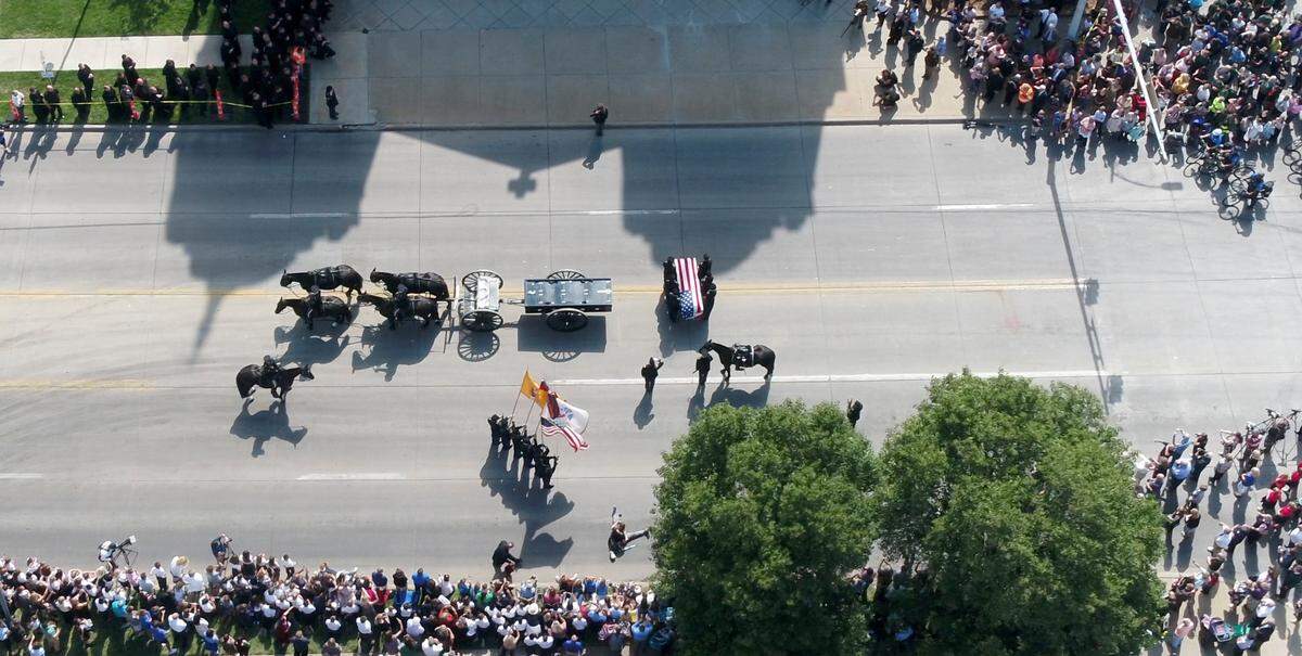 A horse-drawn caisson leads the body of Father Emil Kapaun to the Cathedral of Immaculate Conception in downtown Wichita on Wednesday afternoon. Kapaun, a Medal of Honor recipient, died in a North Korean prisoner of war camp in 1951. His remains were identified earlier this year and today he was finally laid to rest. (September 29, 2021)