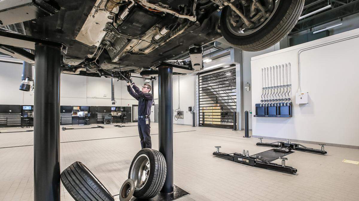 A BG Products employee works on a vehicle in the company's new Proving Ground automotive testing lab.