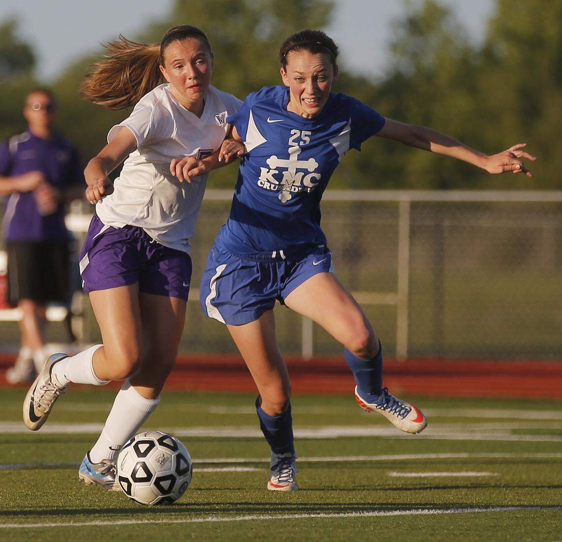 Kapaun’s Grace Hagan, right, fights for the ball with Valley Center’s Kennedy Weaver, left, in the 5A quarterfinal at Valley Center Tuesday. (May 21, 2013)