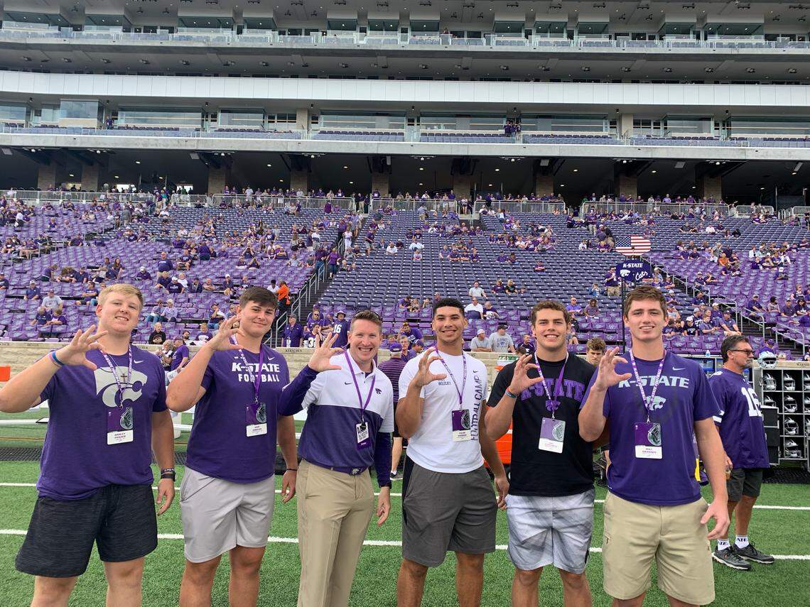 Taylor Braet poses with Kansas State football recruits before a game in Manhattan.