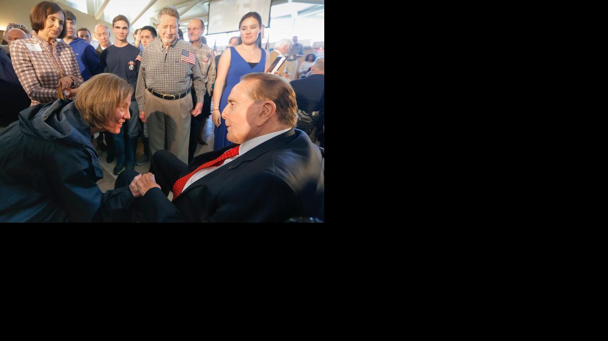 Former Sen. Bob Dole, 90, is greeted by Keri Meinking during an event at the Dole Institute of Politics in Lawrence. Dole made a return trip to Kansas last month to thank people from across the state for their support during his years serving the state in Washington, D.C. (April 22, 2014)


