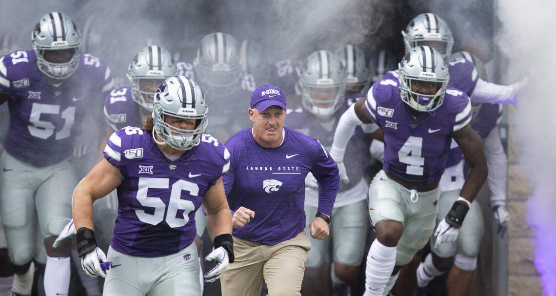 New Kansas State football coach Chris Klieman leads his team onto the field before their game against Nicholls State on Saturday night at Bill Snyder Family Stadium.