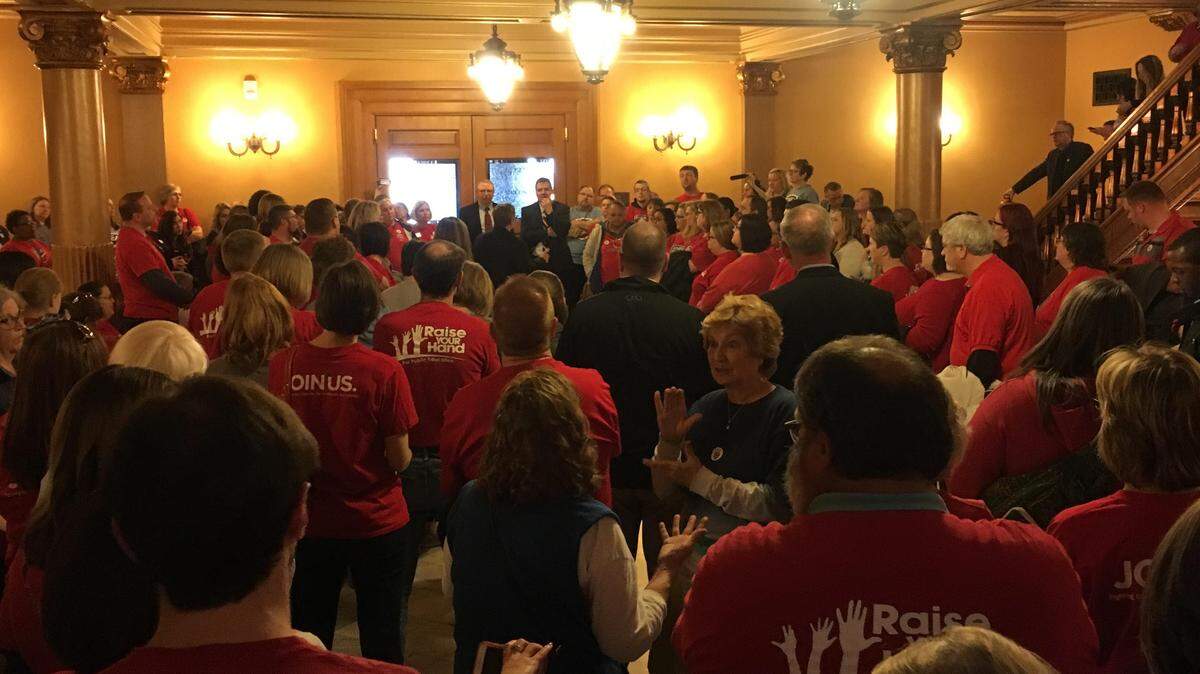 Teachers gathered in the Statehouse on Saturday afternoon as lawmakers debated school funding.