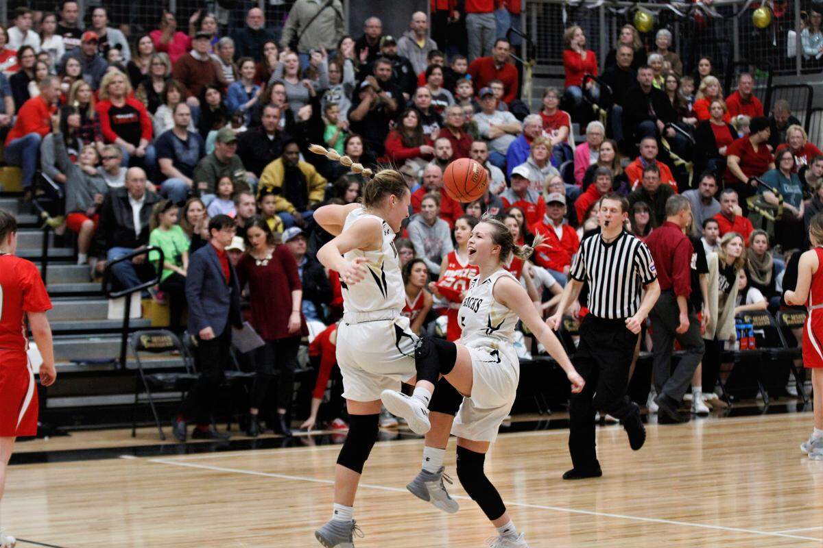 Maize South junior Katie Wagner (left) and senior Zayda Perez (right) jump in celebration of their 54-47 win over crosstown rival Maize on Friday night. (Feb. 1, 2019)