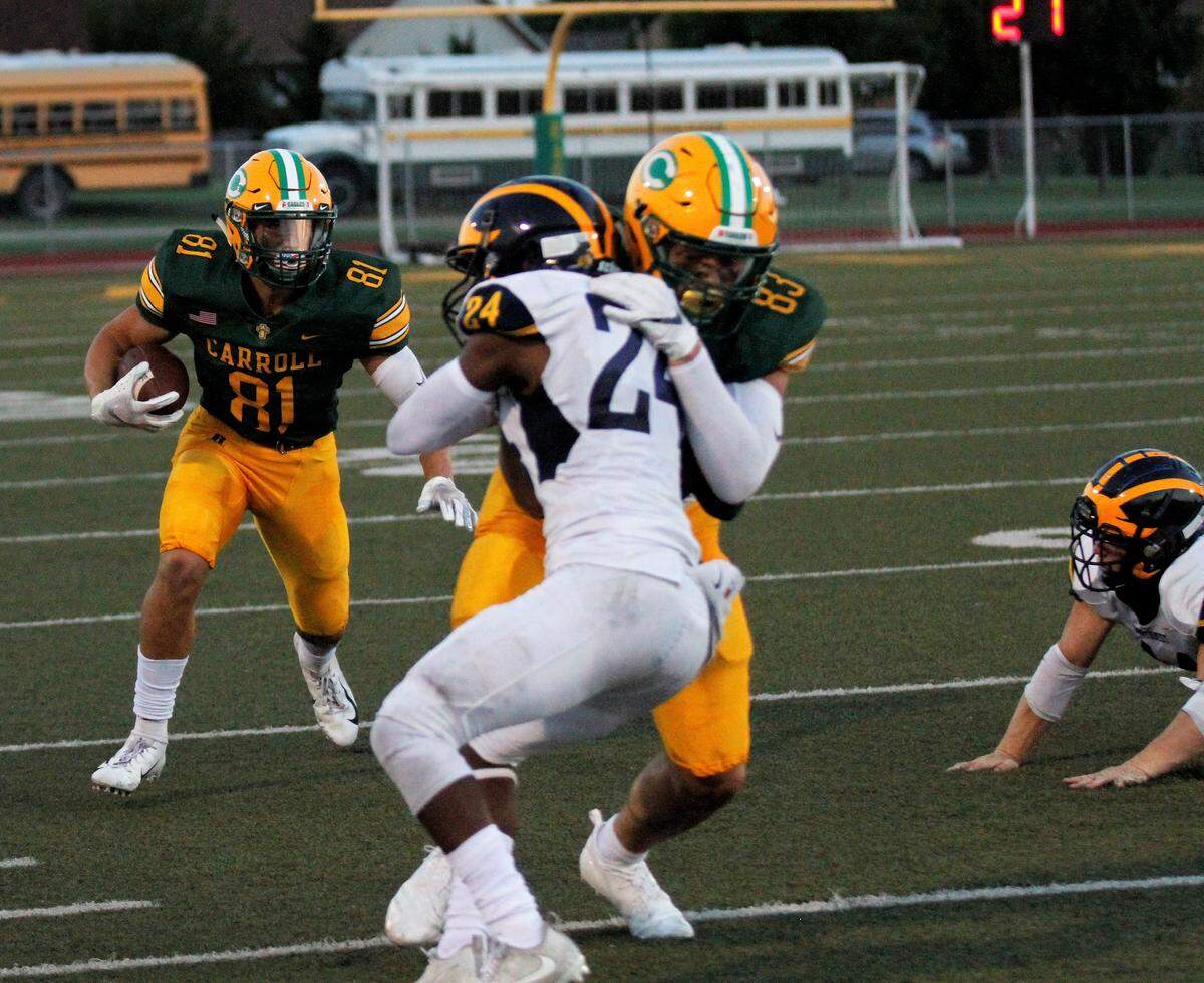 Bishop Carroll seniors Mason Baalman and Clay Cundiff link up on a screen pass against Wichita Northwest during the Grizzlies 23-22 win over the Golden Eagles on Friday night. (Aug. 31, 2018)