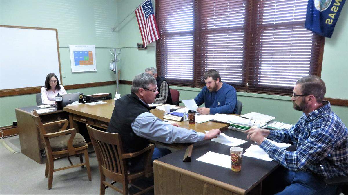 The Chautauqua County Commission and staff meet in a small room, unmasked. The county is the only one in Kansas not in a state of COVID emergency.