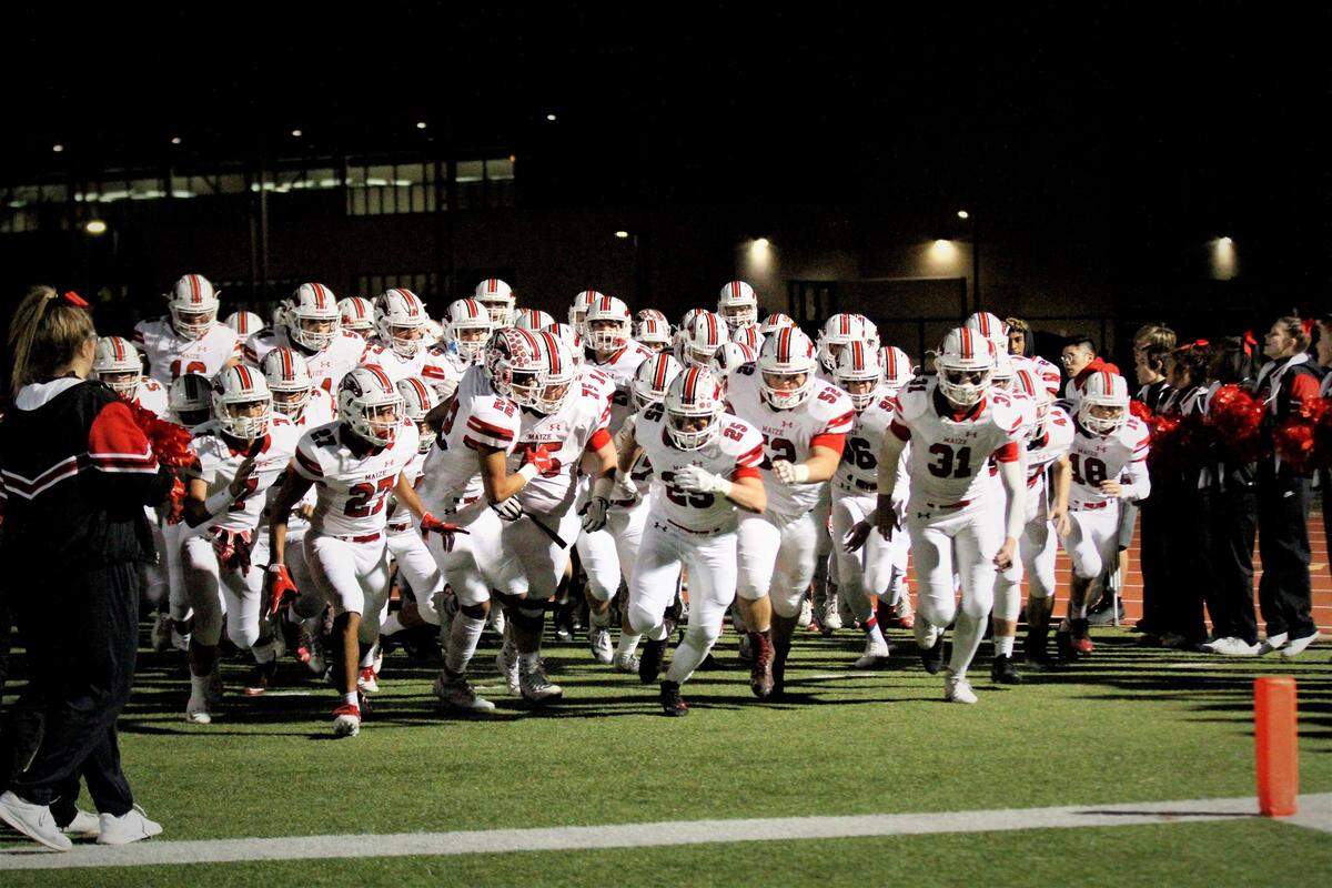 The Maize Eagles run onto the field.