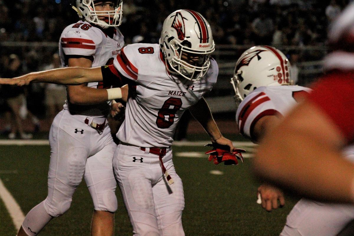 Maize junior defensive back Camden Jurgensen celebrates with a teammate after his 95-yard kickoff return for a touchdown in the Eagles’ 21-0 shutout of Campus on Friday night. (Sept. 14, 2018)