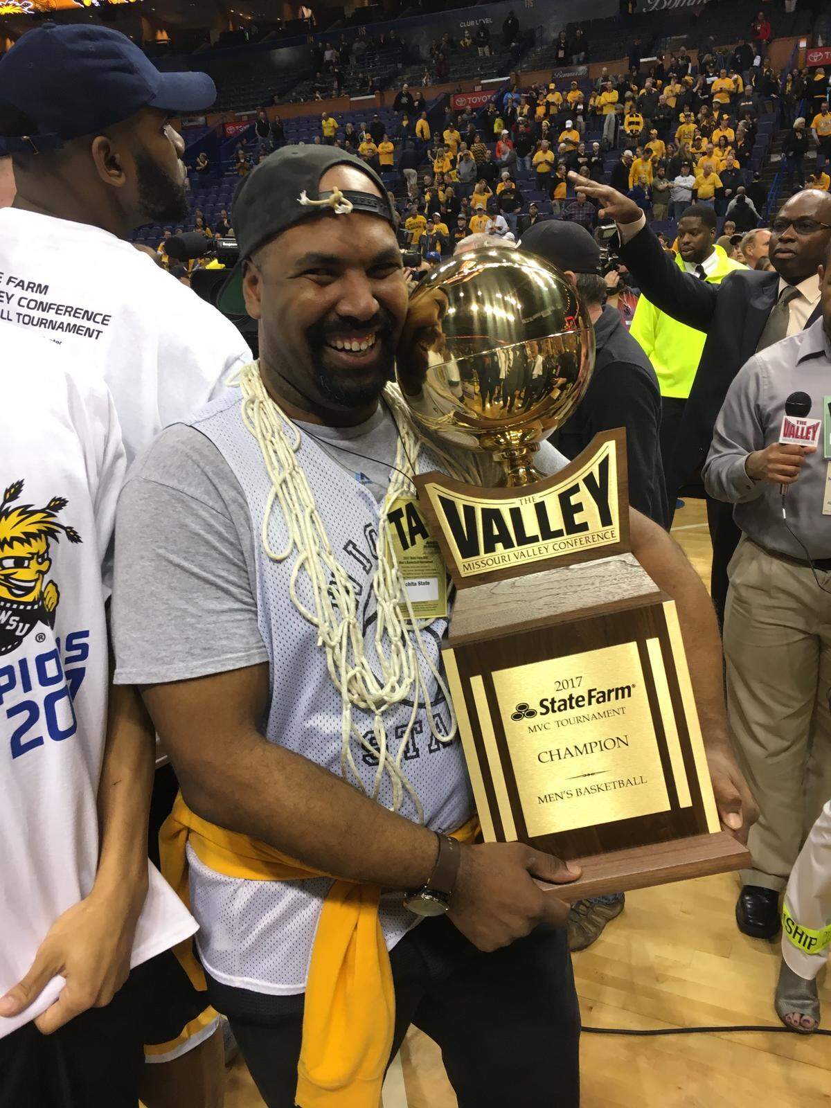 Daxton Miller poses for a picture with the Missouri Valley Conference tournament championship trophy after Wichita State won Arch Madness in 2017.