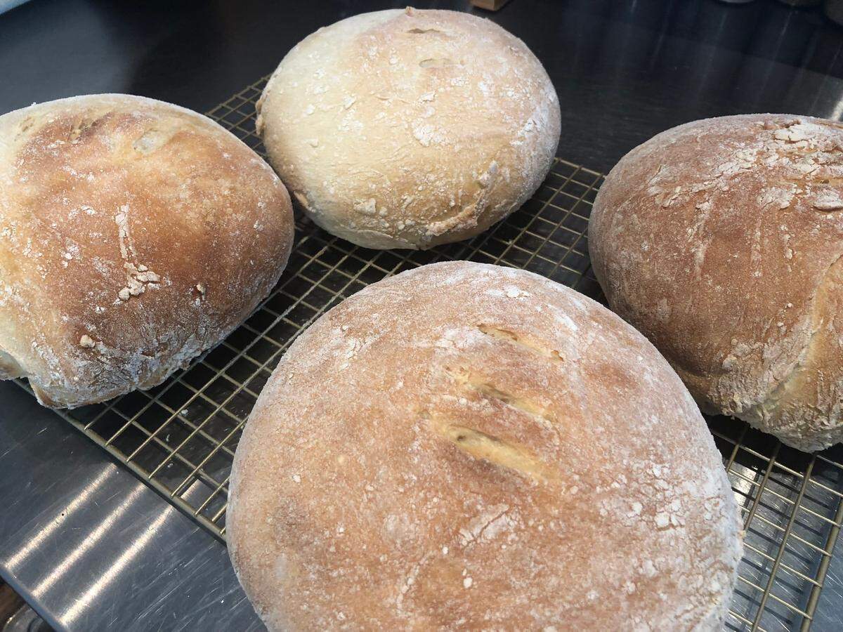 Stan Lerner says he makes his sourdough rounds by hand, using a wooden spoon to mix the dough.