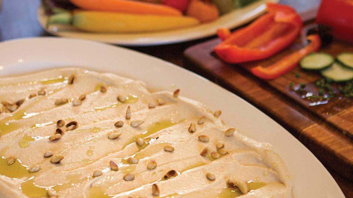Hummus becomes a meal with topped with spiced ground beef and tomatoes.