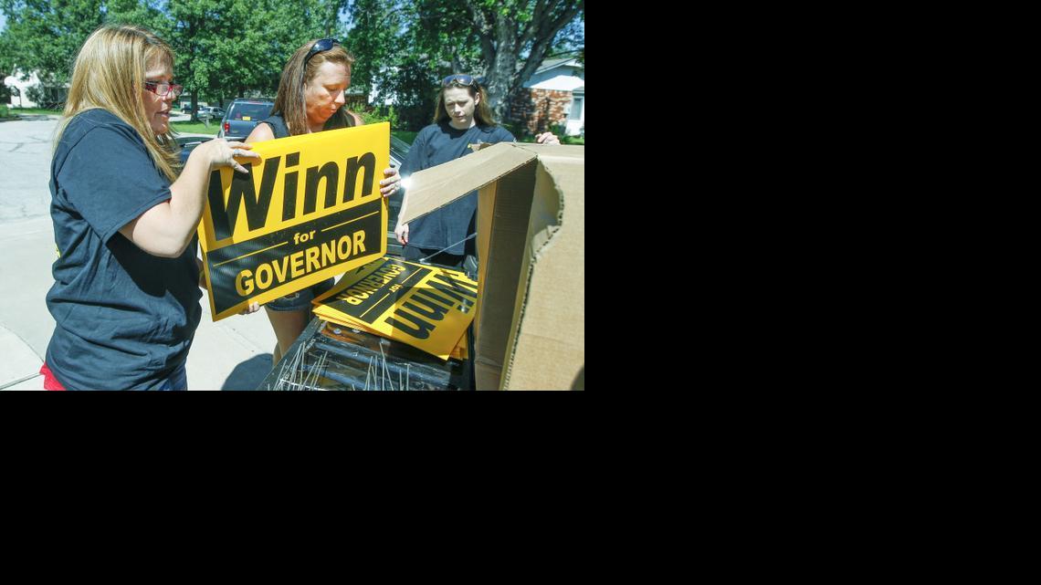 Republican candidate for Kansas governor Jennifer Winn, left, gets some help Thursday from supporters Shelly Pribanic, center, and Shona Banda in distributing yard signs for her campaign.  (July 3, 2014)


