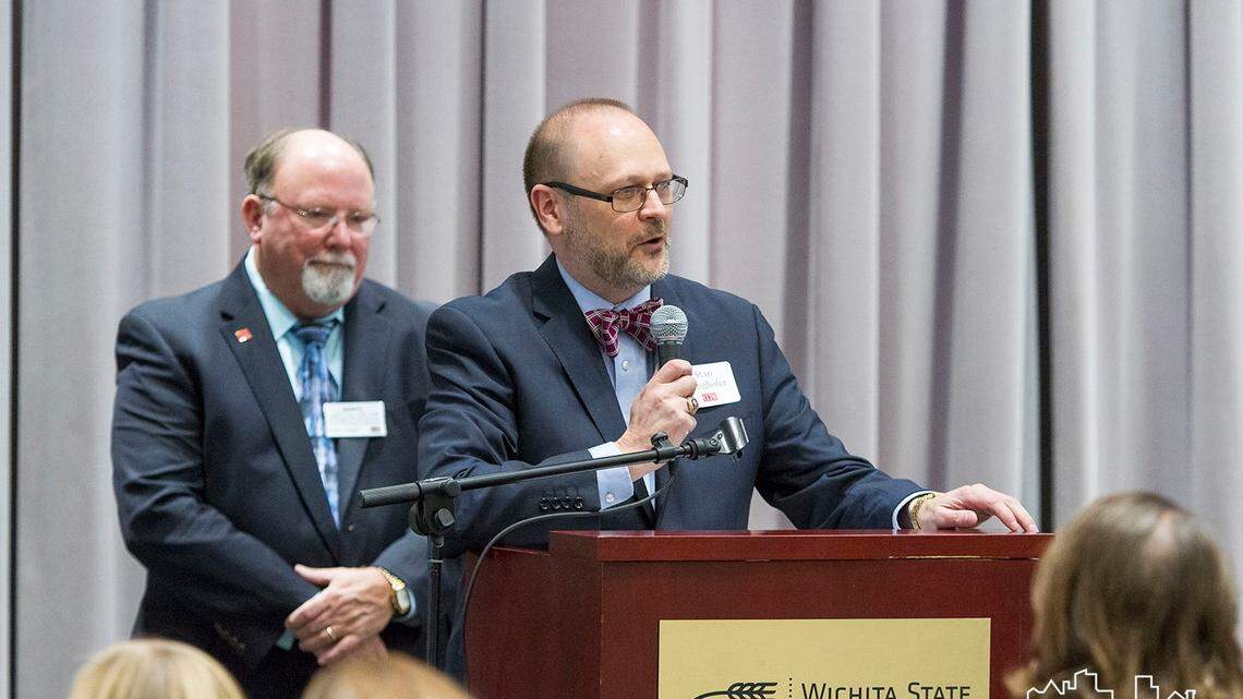Stan Longhofer, at the microphone, has created his final housing forecast as director of the Center for Real Estate at Wichita State University. He started giving forecasts 25 years ago and said the latest one is a bit of a full-circle moment.