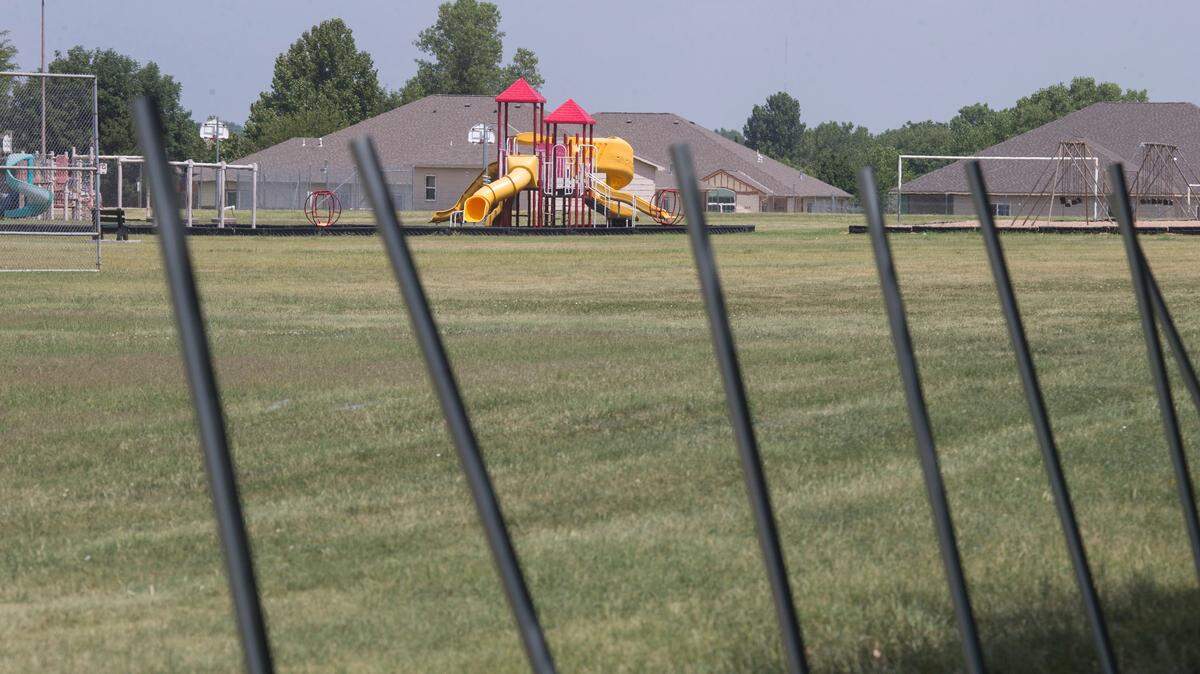 Monica Marks is gathering signatures to keep USD 259 from locking up the playground at Gammon Elementary. Workers started putting up a chain-link fence around the playground on Monday, and Marks and other neighbors are upset about the area's being closed off.