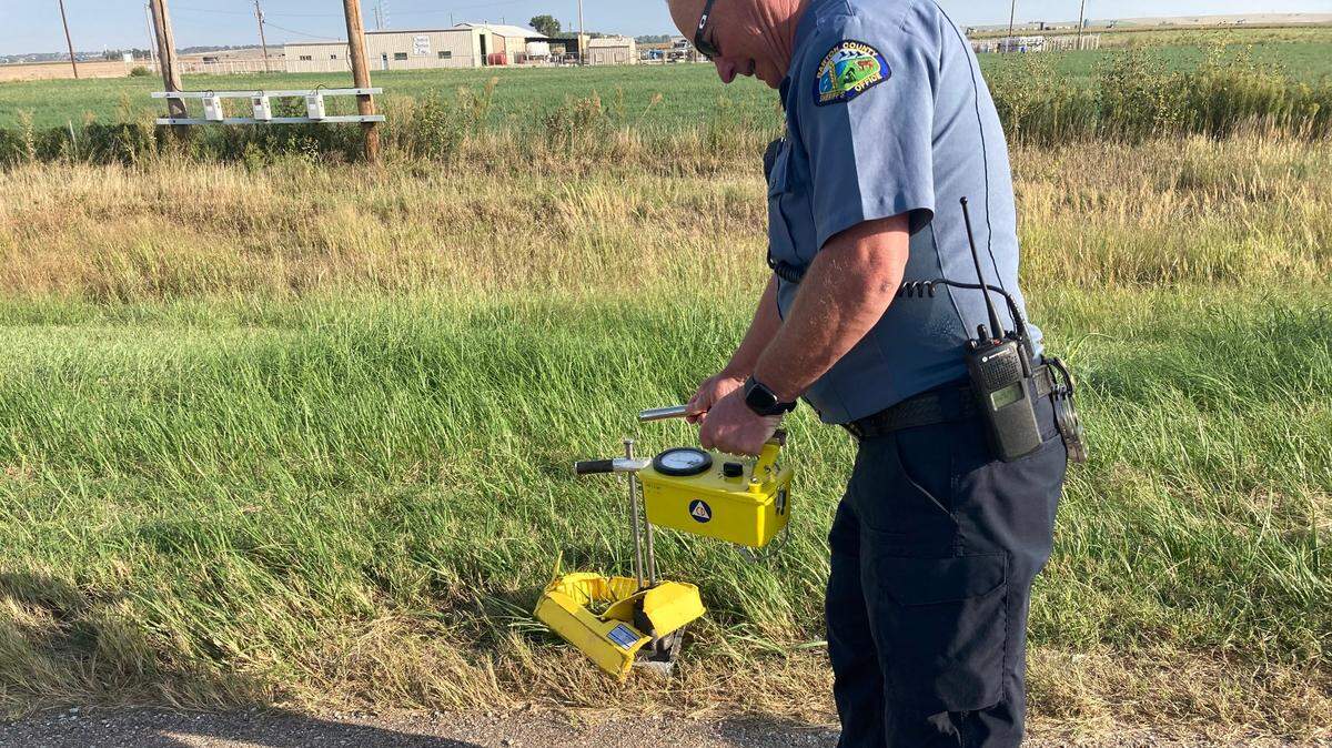 Barton County Sheriff’s Office Lt. Steve Billinger checks debris with a Geiger counter.