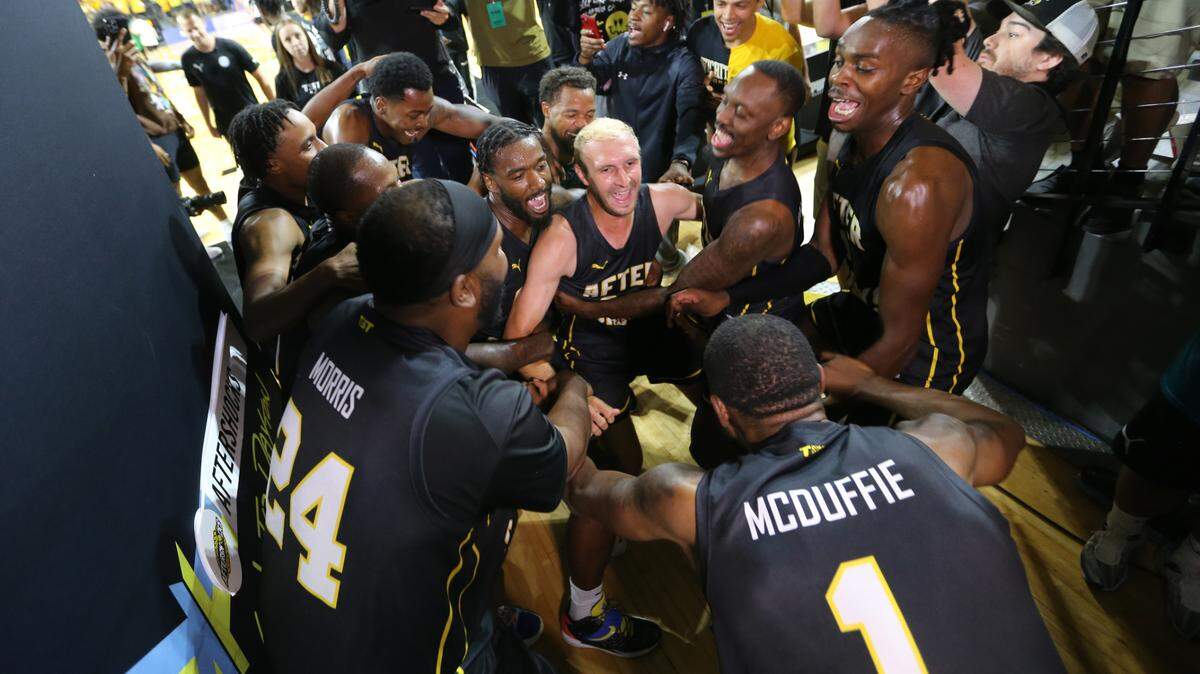 The AfterShocks dance together after winning the regional championship in The Basketball Tournament at Koch Arena in 2022.