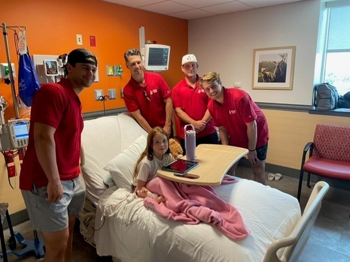 Buster Posey (middle left) has made it a point to visit Wesley Children’s Hospital each time he has come to Wichita to present the National Catcher of the Year award.