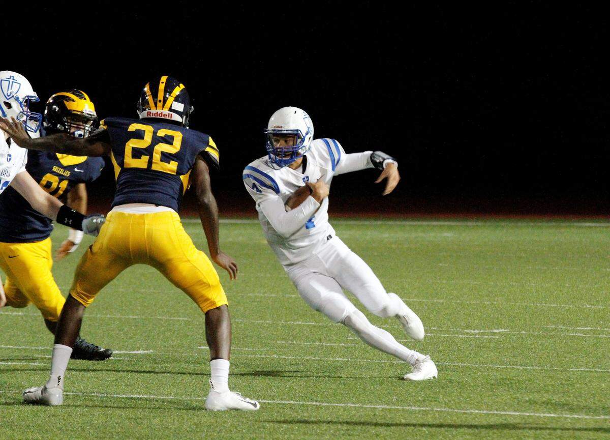 Kapaun’s Jarius Kennedy cuts back a run during the Crusaders’ 55-26 loss to Wichita Northwest on Friday. (Sept. 28, 2018)