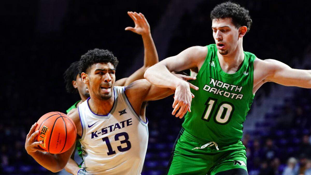 Kansas State guard Mark Smith (13) drives against North Dakota forward Tsotne Tsartsidze (10) during the first half of an NCAA college basketball game Sunday, Nov. 28, 2021, in Manhattan, Kan. (AP Photo/Nick Krug)