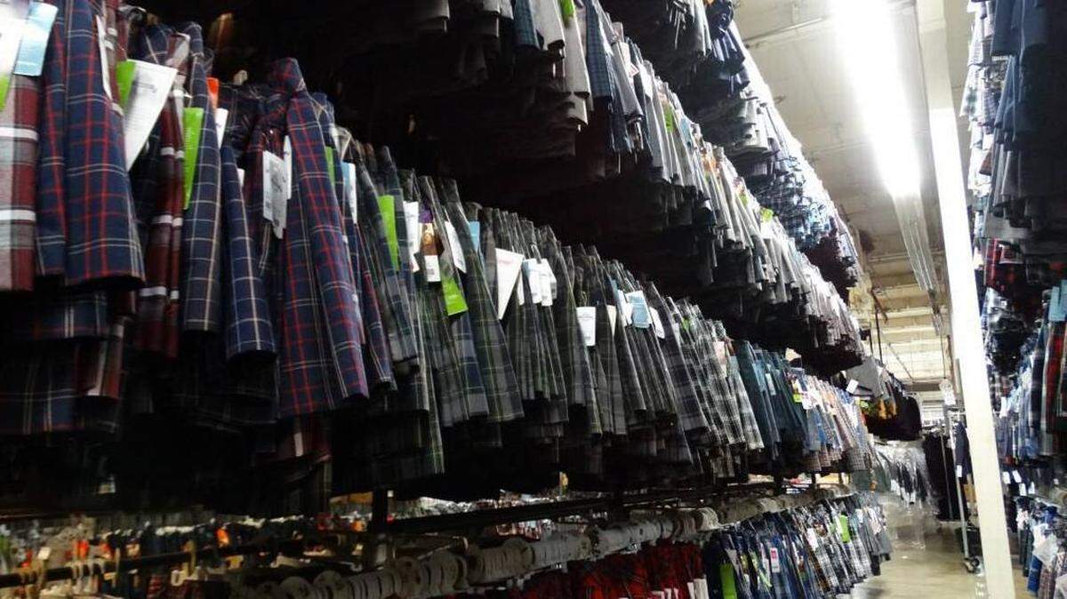 Plaid skirts fill an aisle of the Schoolbelles Uniform Company factory in Cleveland, Ohio. The company was selected as the preferred vendor for Wichita-area private schools and is celebrating its grand opening on Carriage Parkway this week.