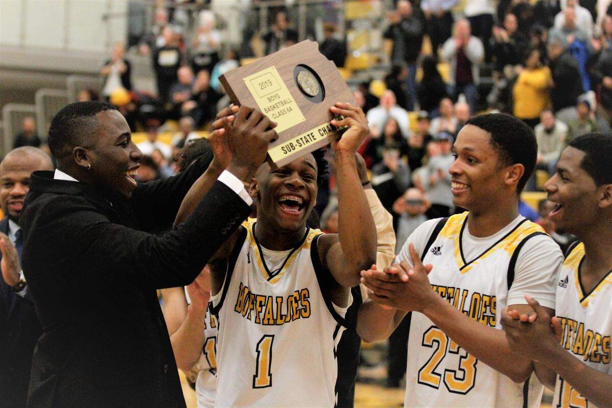 Wichita Southeast coach Joe Mitchell, Jackie Johnson III and Micah Jacques
