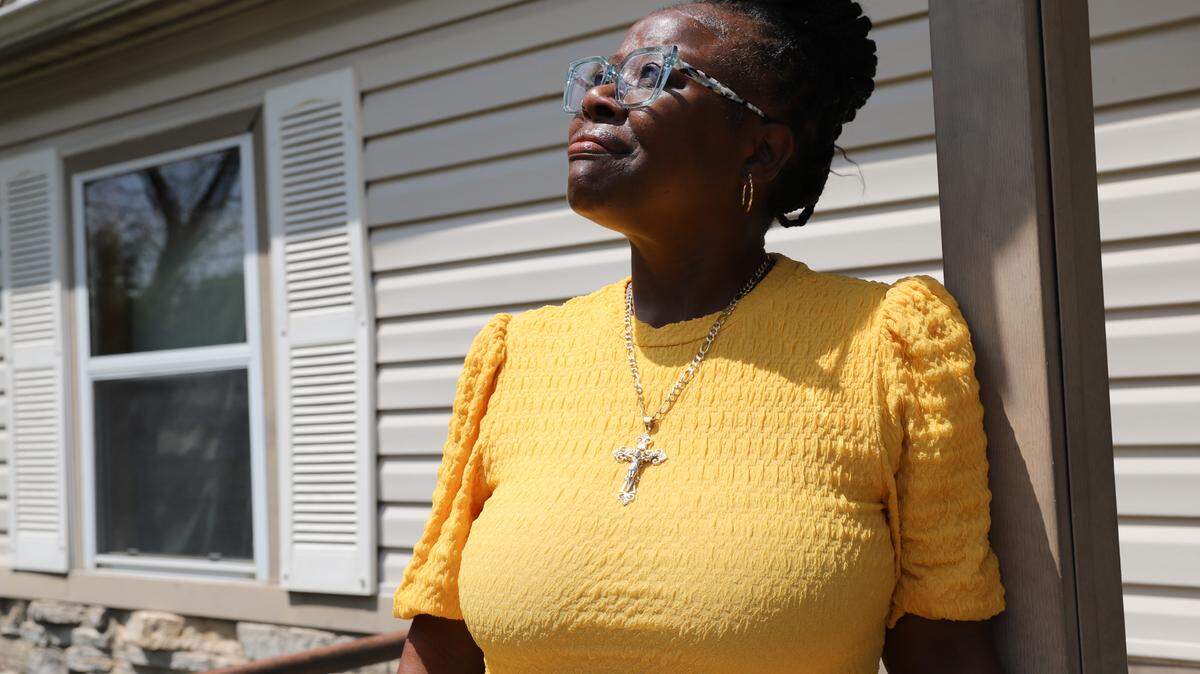 Lawonder Markham stands on the porch of the home she raised her daughter in and now owns.