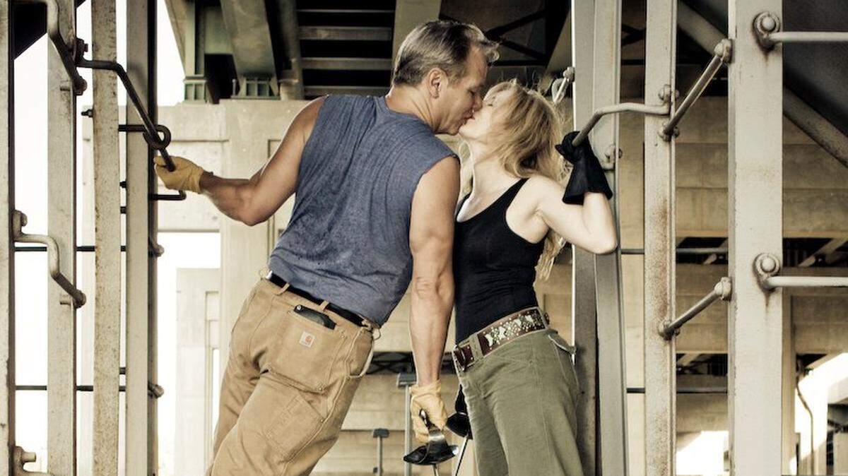 A photographer caught an impromptu kiss between Ed and Danette Baker, two staples in the Wichita theater community who were sparring for a photo shoot on a train under Kellogg in 2011. This picture has been circulating on social media following Danette Baker’s death from lung cancer on Saturday.