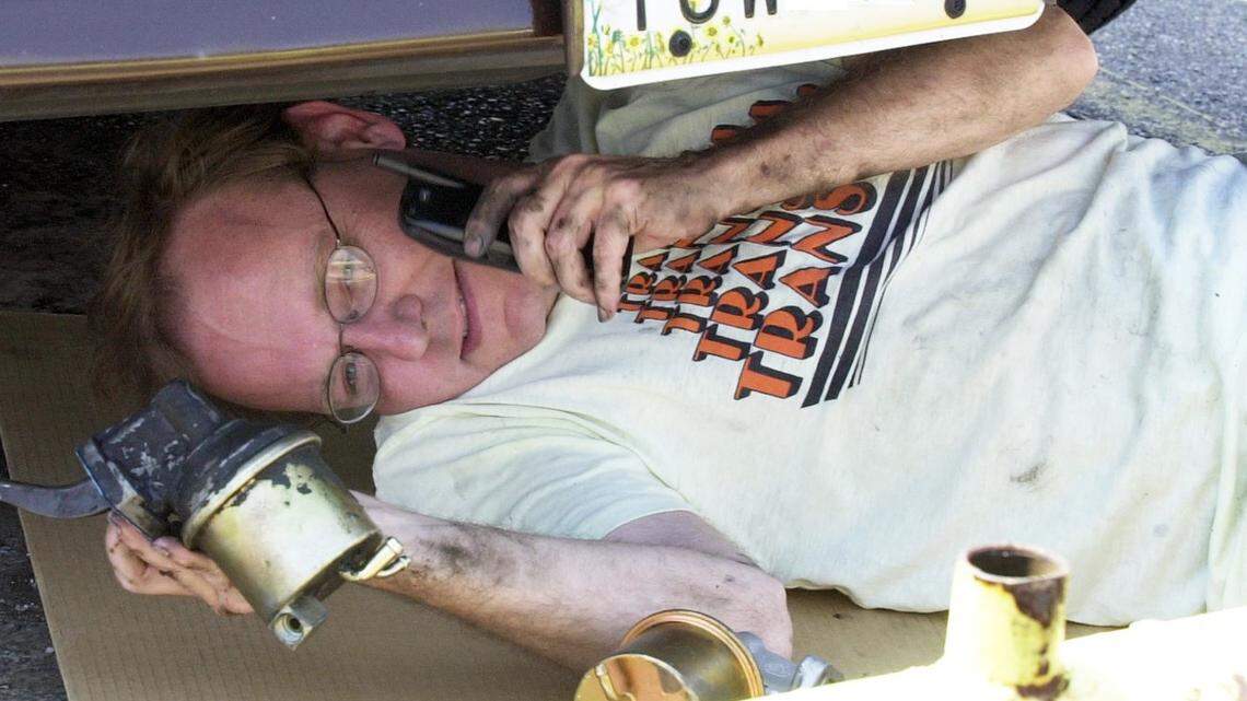 Dion Lefler works underneath his truck in the Eagle’s parking lot at 825 E. Douglas on June 9, 2003.