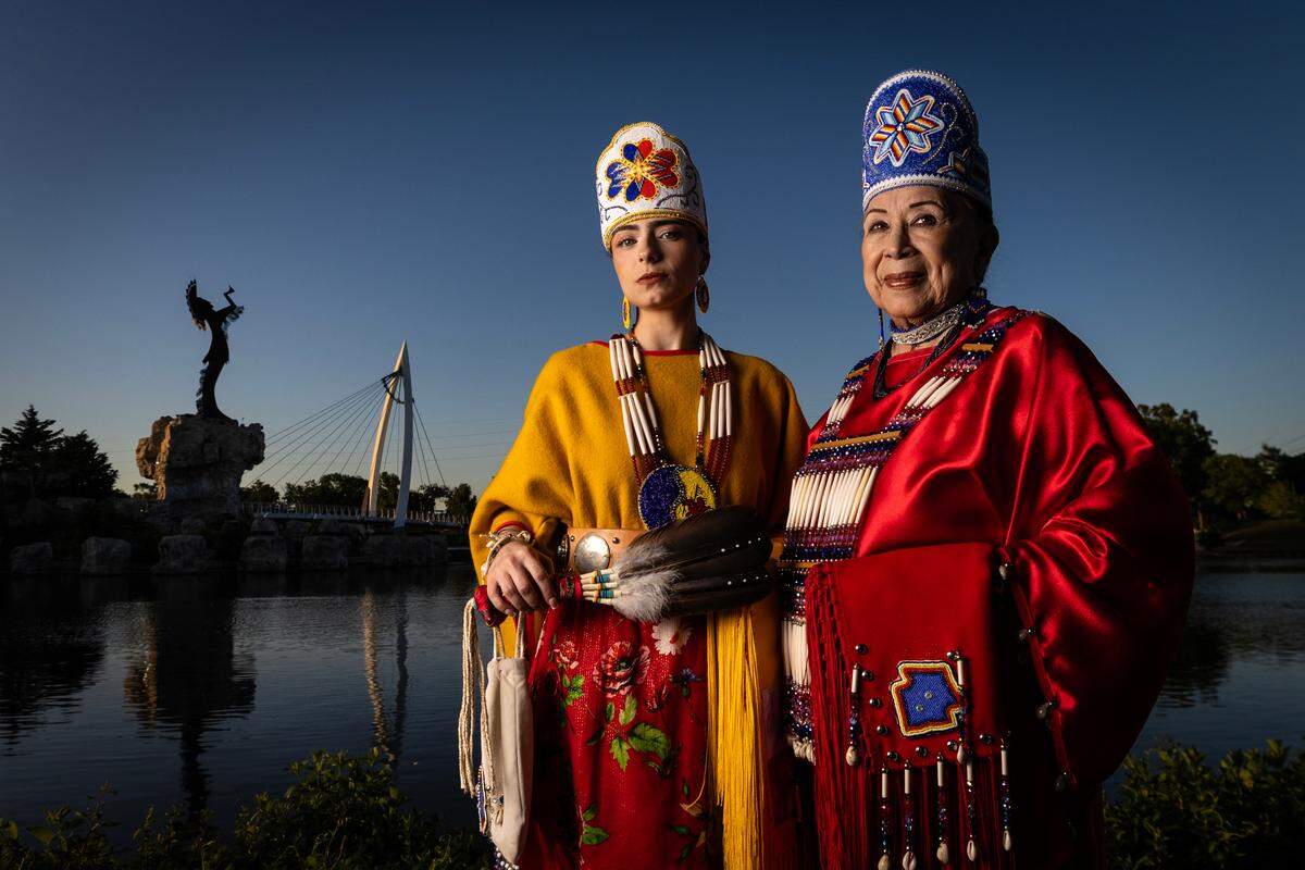 Susan Seal, right, and her granddaughter, Hannah Ramahi, stand near Blackbear Bosin’s Keeper of the Plains sculpture in Riverside. Seal said her uncle “knew that he wanted something that would stand out, something that would mark what Wichita is.”