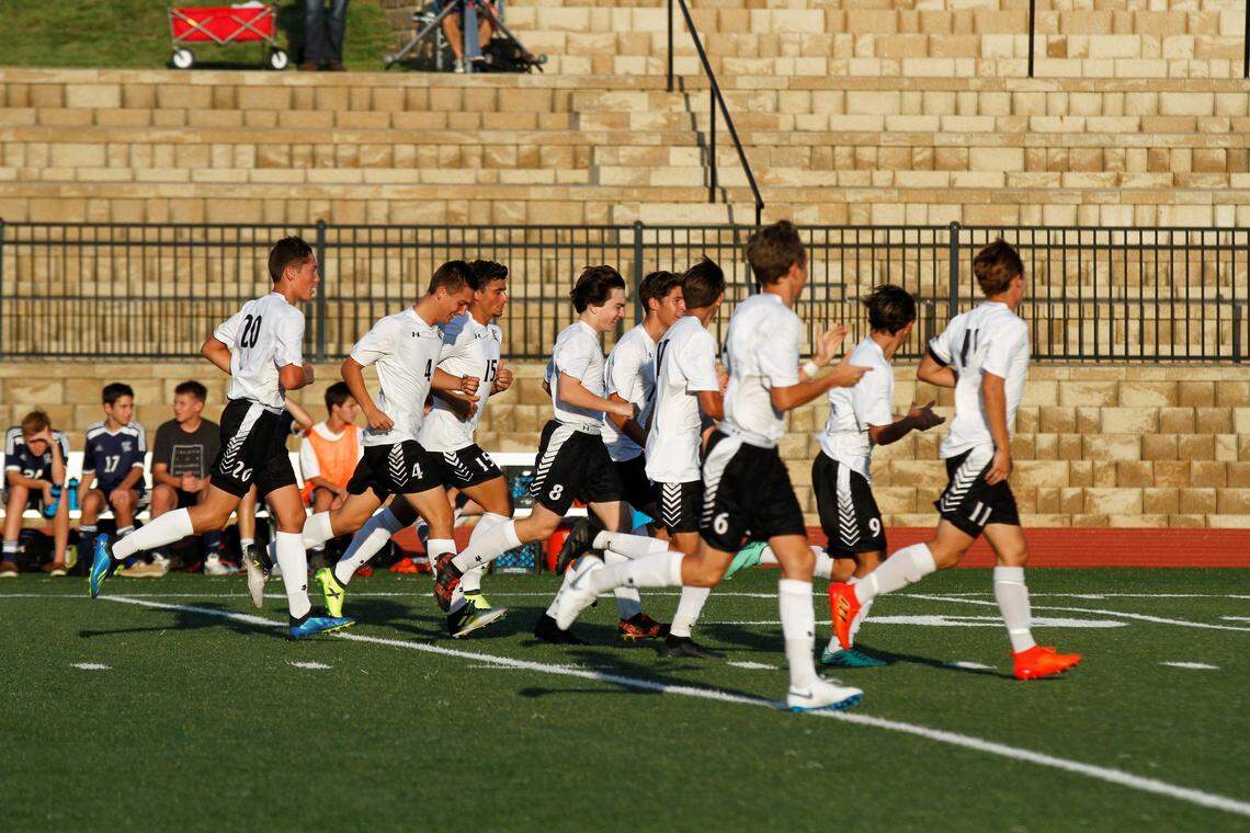 The Maize South boys soccer team celebrates sophomore midfielder Adam Dyer’s goal in the Mavericks’ 5-1 win at Trinity Academy on Friday. (Aug 24, 2018)