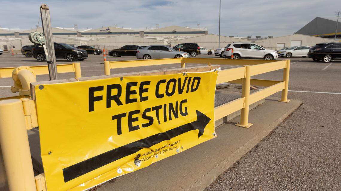 Nearly 100 cars wait in line for their occupants to get a COVID test at Wichita State University’s Molecular Diagnostics Laboratory at 4174 S. Oliver, Building 174H near Spirit AeroSystems, on Tuesday, Jan. 4, 2022.