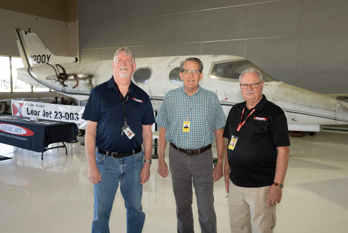 Bill Kinkaid, left, Chris Marshall, center, and Rick Rowe, helped form the Classic Lear Jet Foundation to acquire and restore the plane behind them, the first Learjet sold in 1964. The foundation has now purchased the plane for $90,000.