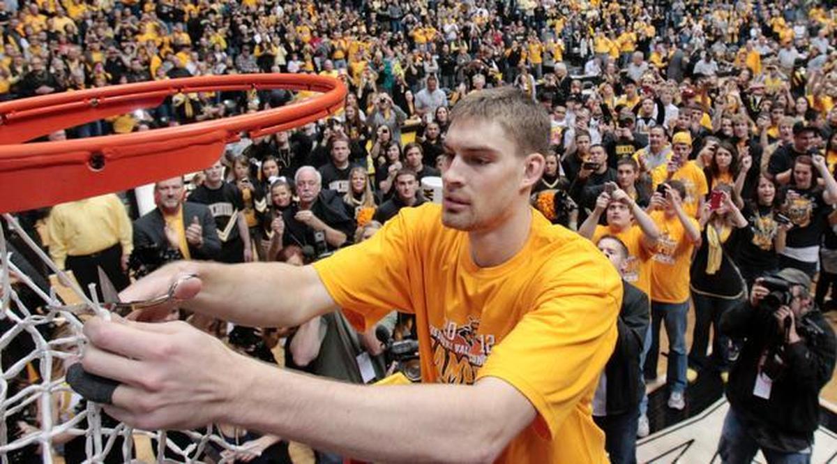 Garrett Stutz takes a cut into the net during a postgame celebration on Saturday afternoon at Koch Arena. (Feb. 25, 2012)