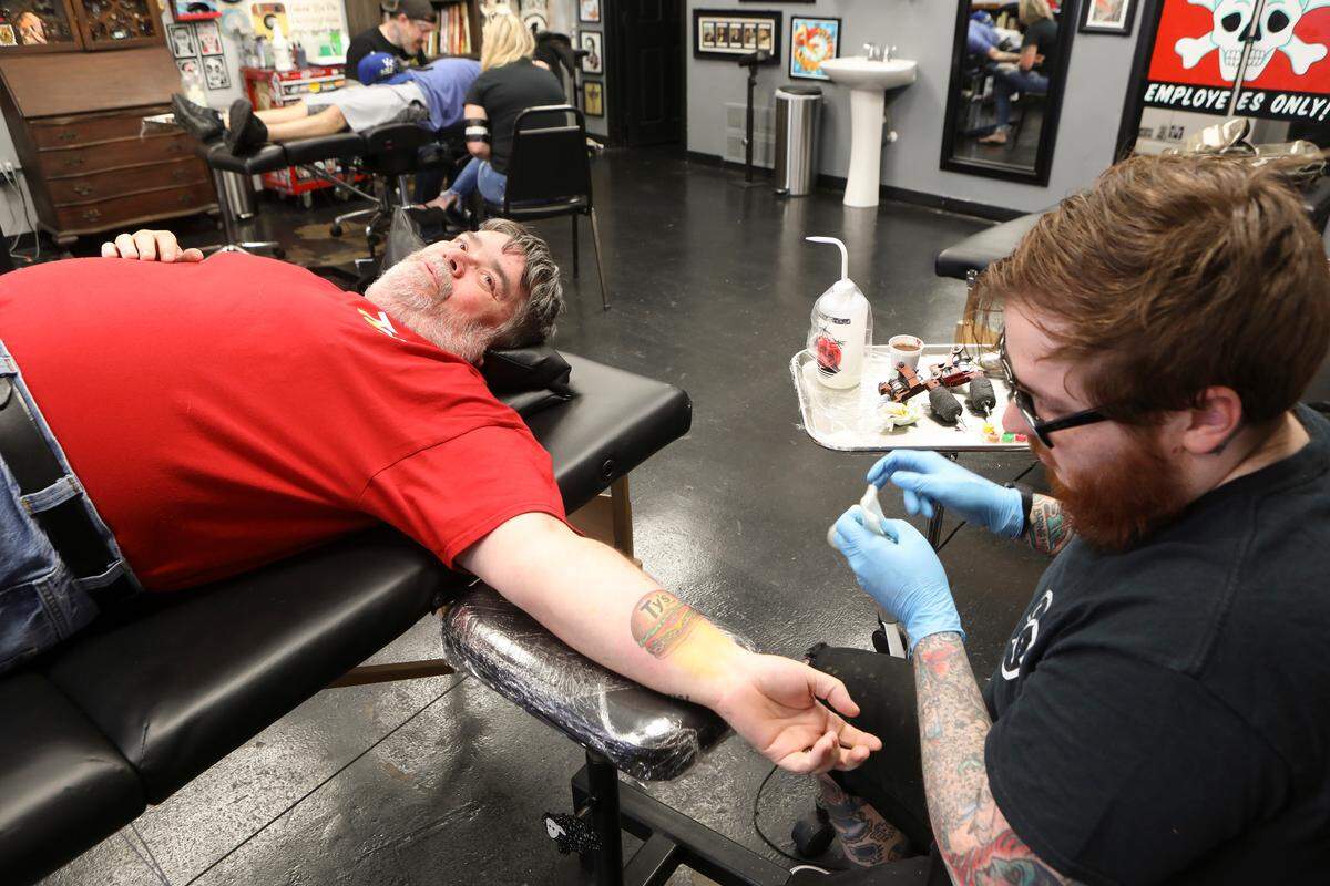 Mark Klamm is pictured in 2019 getting his Ty’s Diner tatoo, which earned him free burgers for life.