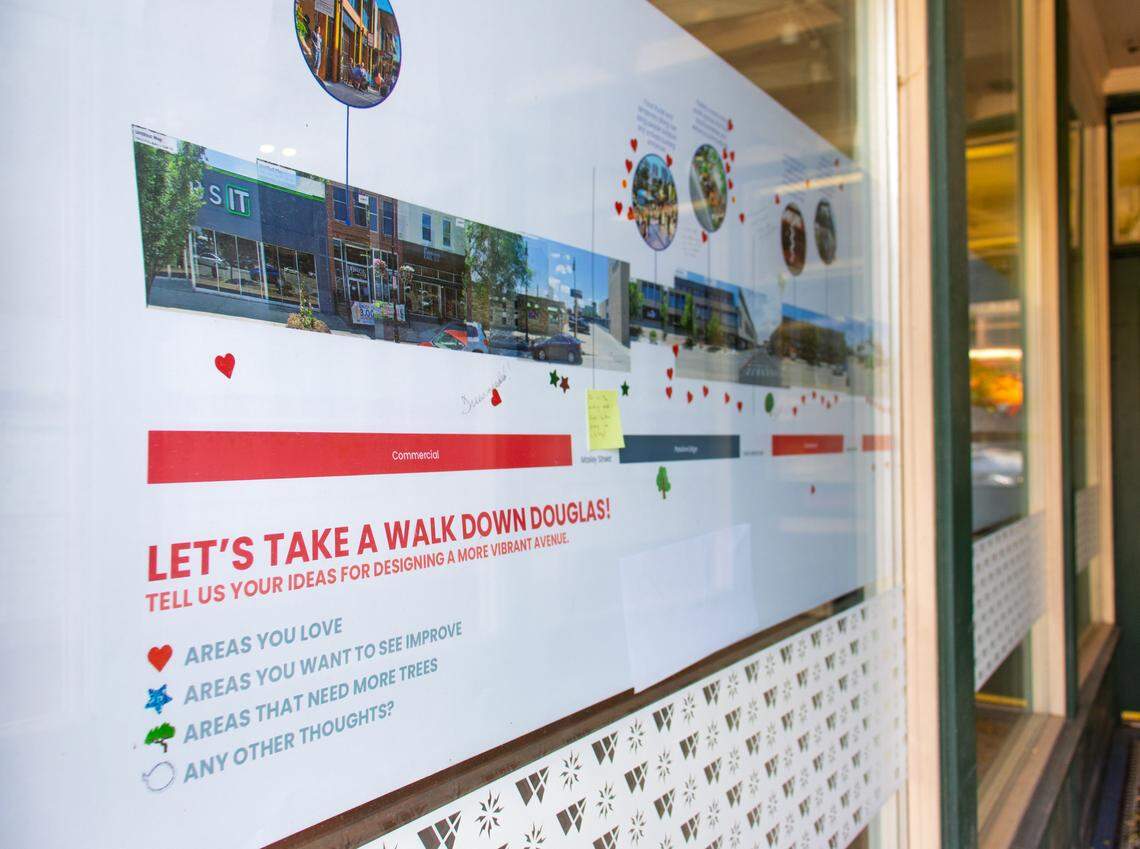 A map of Douglas, marked with stickers and notes from attendees at the second open house, sits on display outside Downtown Wichita's office.
