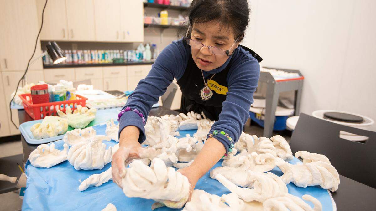 Tomiyo Tajiri works on a ceramics project at Envision that will be a part of the next phase of Gallery Alley downtown. Tajiri is one of five artists selected to create new multisensory sculptures there.