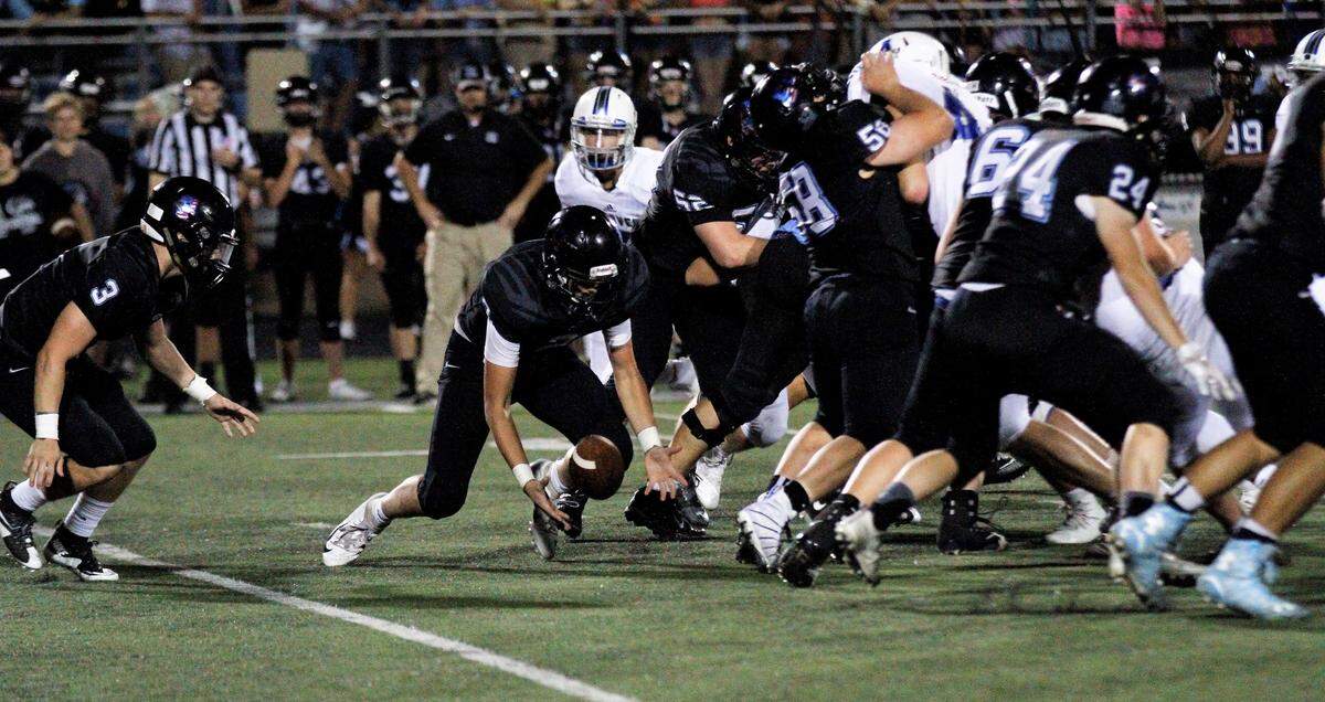 Goddard Eisenhower sophomore quarterback Nick Hogan fumbles the snap during the Tigers’ 30-22 loss to Andover on Thursday night. (Sept. 13, 2018)