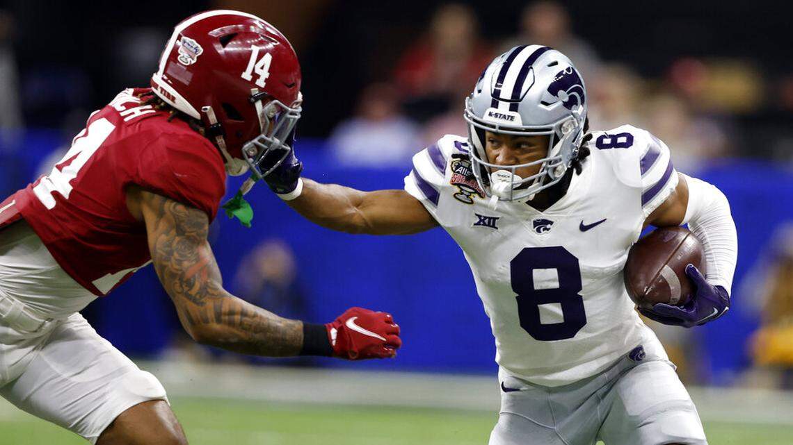 Kansas State wide receiver Phillip Brooks (8) stiff arms Alabama defensive back Brian Branch (14) as he carries the ball during the first half of the Sugar Bowl NCAA college football game Saturday, Dec. 31, 2022, in New Orleans. (AP Photo/Butch Dill)
