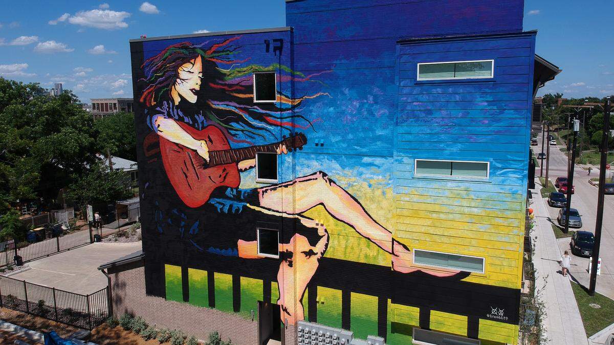 Artist John Bramblitt’s public art work includes this four-story mural on a building in Dallas’ Bishop Arts District.