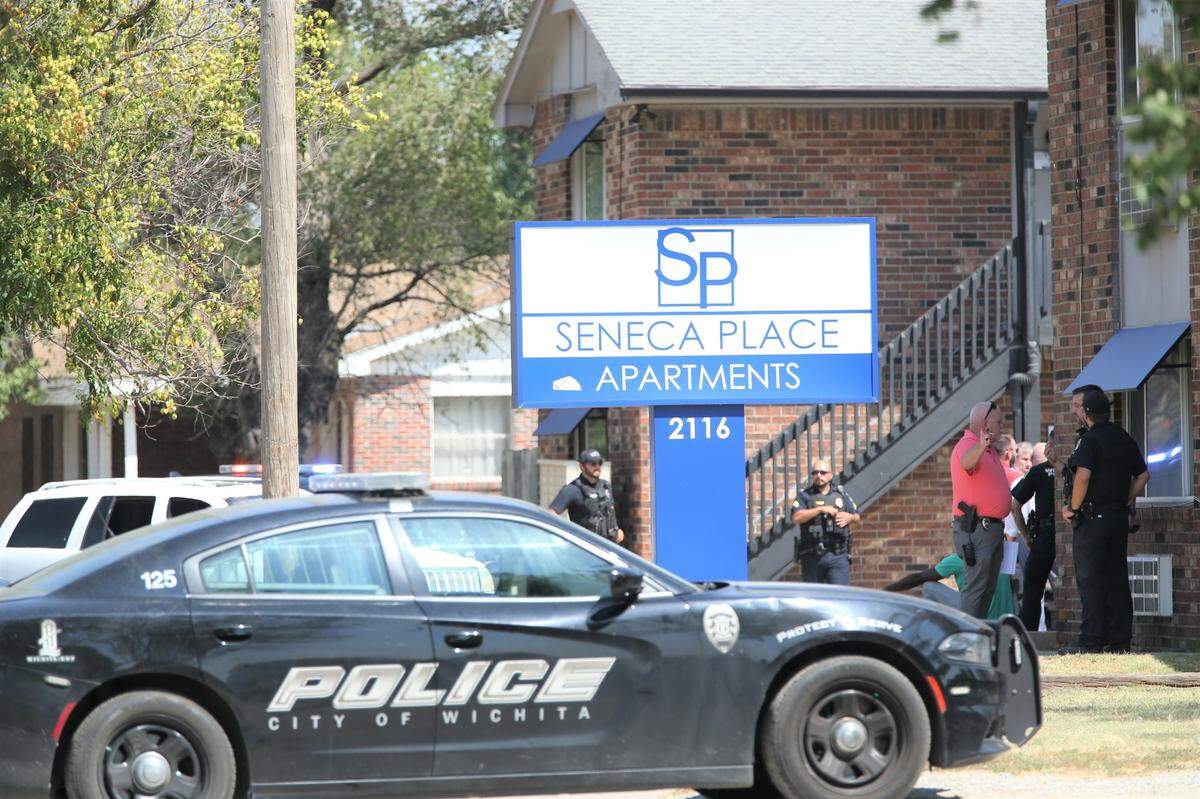 Wichita police officers and detectives interviewed residents at the Seneca Place Apartments after a man was found shot to death in an apartment unit.