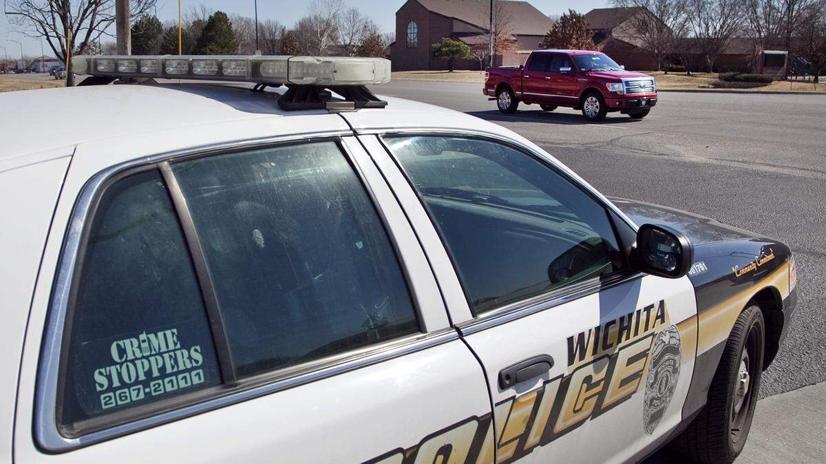 A Wichita police officer monitors traffic on West 21st.