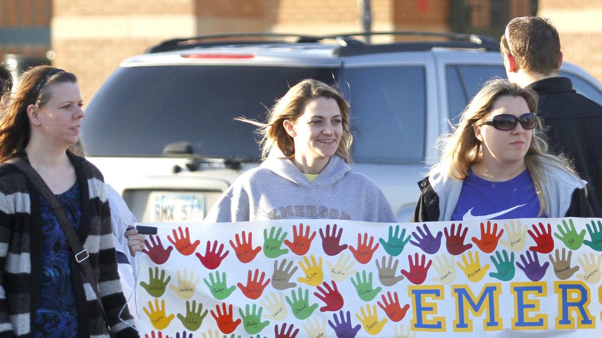 A group of Emerson Magnet School supporters held up signs of support for their school in front of Wichita North High School where the Wichita school board meets. The BOE is expected to decide whether to close five schools and shift attendance boundaries. (March 5, 2012)







