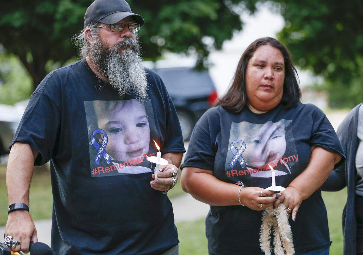 Zak and Nancy Woolheater hold candles Monday during a vigil in Riverside Park in memory of their grandson, 2-year-old Tony Bunn, who was killed by blunt force trauma in May. The boy’s mother and her boyfriend are charged with murder.