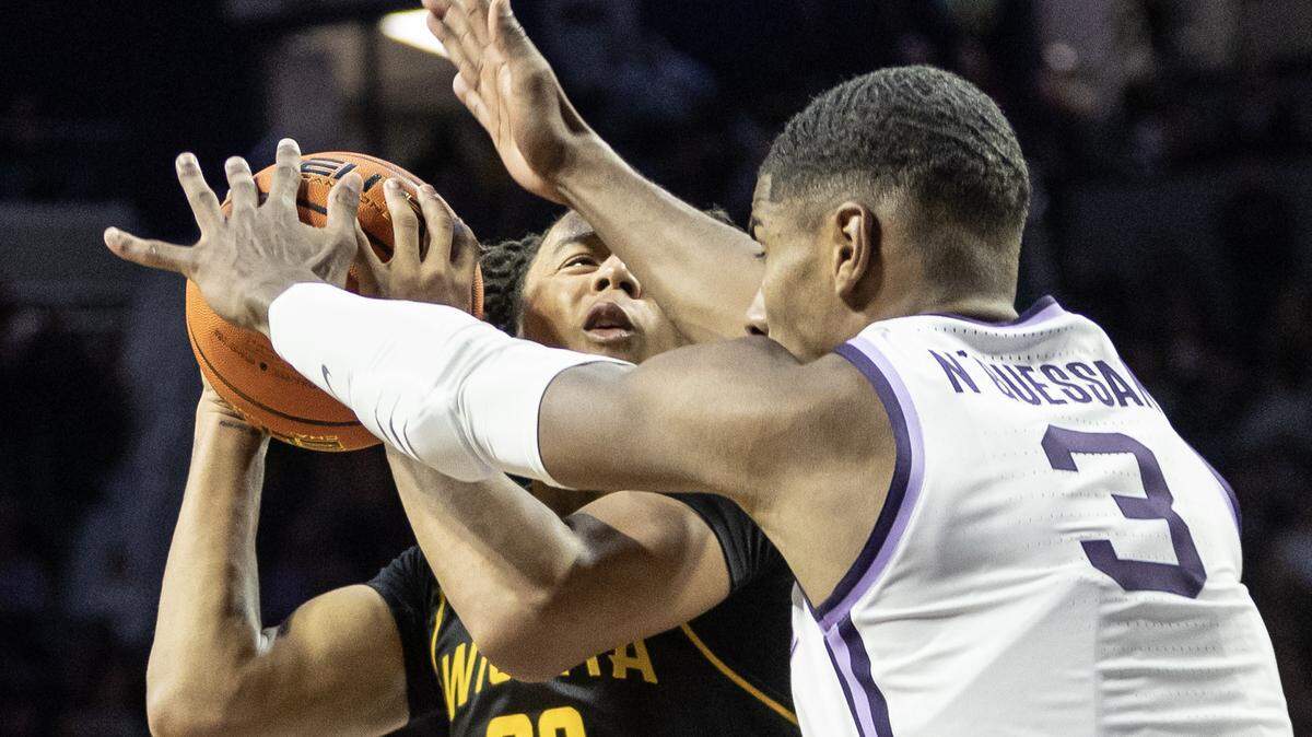 Wichita State’s Shammah Scott gets smothered by Kansas State’s David N’Guessan during the second half on Saturday in Manhattan.