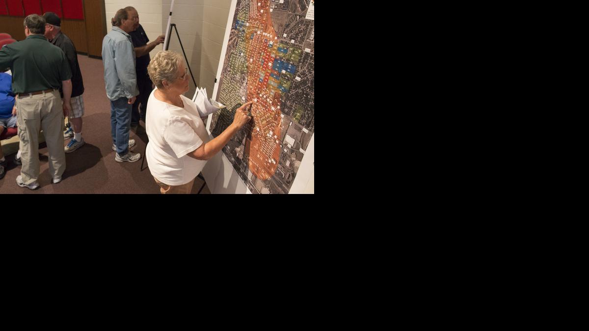 Judy Blue looks at a map of an area in west Wichita that has possible groundwater contamination before the start of a public meeting last month. (April 10, 2014)

