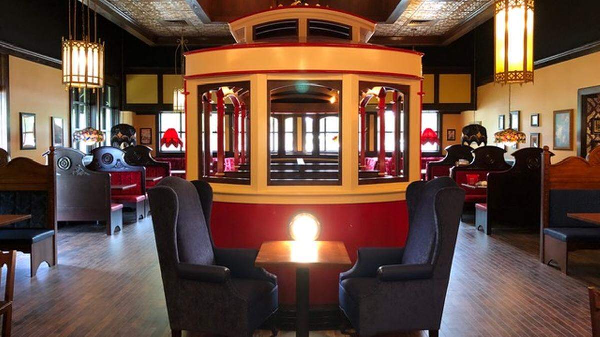 The Old Spaghetti Factory is known for having a replica trolley car with tables inside set up in the dining room.