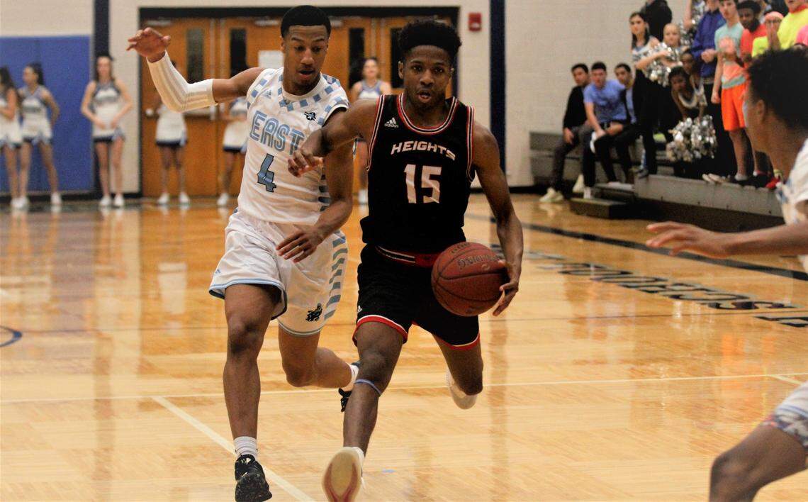 Wichita Heights’ Jaxon Pillich (15) drives on Wichita East’s Daylan Jones (4) during the Falcons’ 66-58 win over the Aces on Wednesday night. (Jan. 2, 2019)