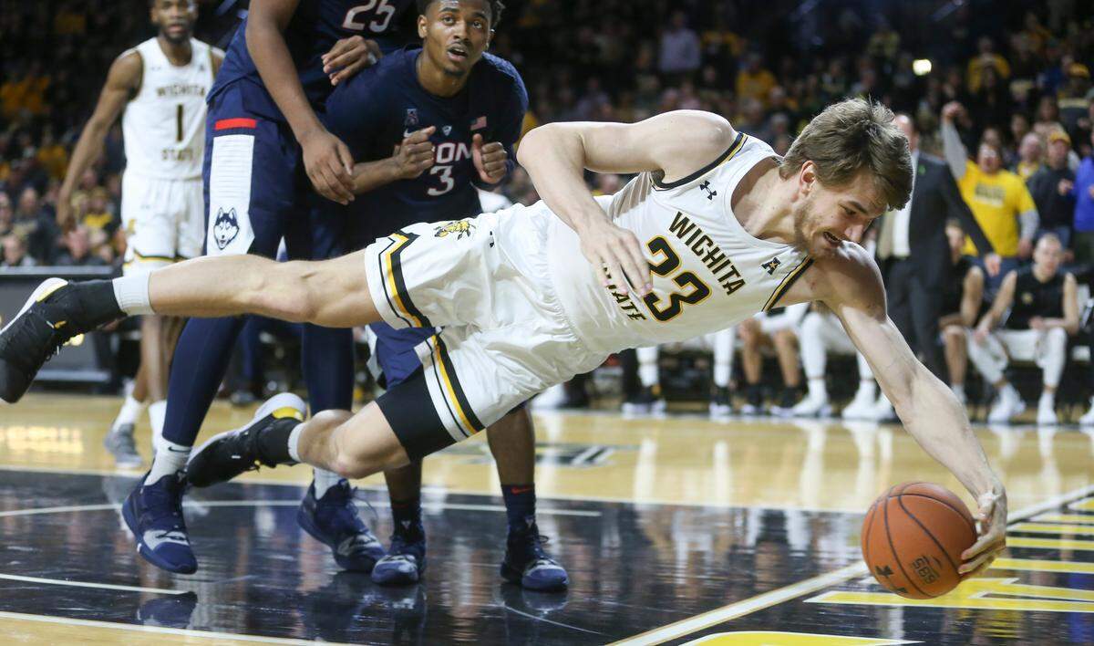 Wichita State center Asbjorn Midtgaard dives out of bounds for the ball against Connecticut during the second half of their game at Koch Arena on Thursday.